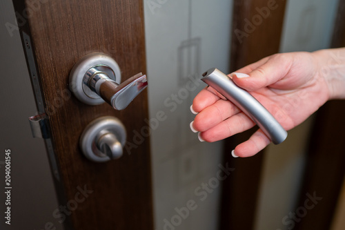 Broken Metal Door Handle in Female Hand Close Up Concept of Low Quality Hardware or Home Repair