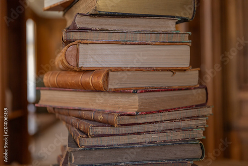 stack of old books on a shelf