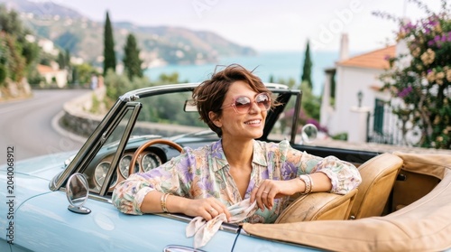 Woman enjoying a scenic drive in a vintage convertible along a coastal road