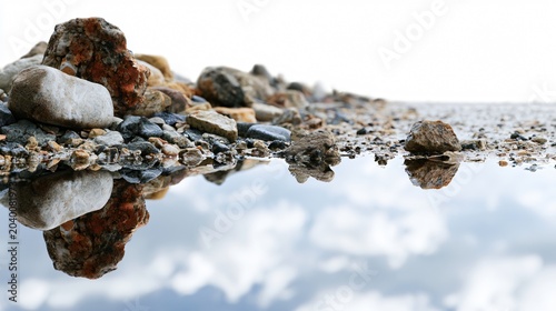 Serenity: Reflecting Sky in Water Puddle near Road with Rocks and Gravel