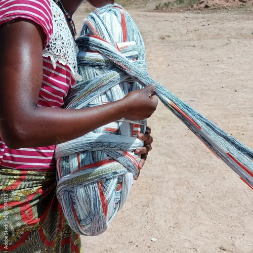 Принти на полотні In Burkina Faso, a woman winds threads to make strips of fabric, to make clothes