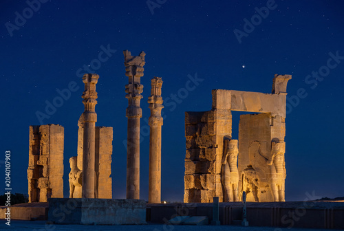Majestic Gate of All Nations in the ancient city of Persepolis illuminated at night under a starry sky, Shiraz, Iran