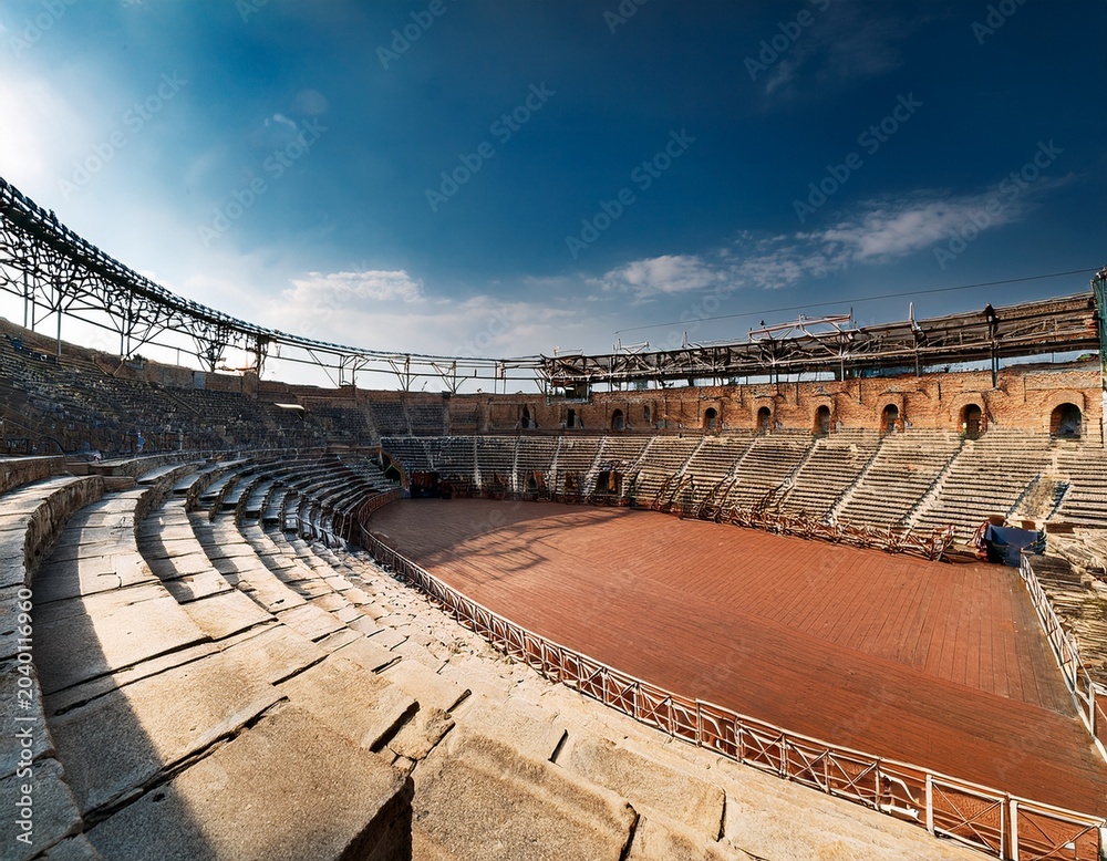 Fototapeta premium ancient amphitheatre wide view with empty seats and event stage rigging