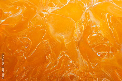 Orange jelly displayed in a close view shows its shiny texture and bright color