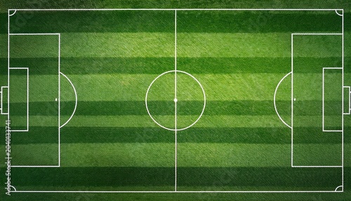 top down aerial view of a professional green soccer field with white markings and alternating mowed stripes