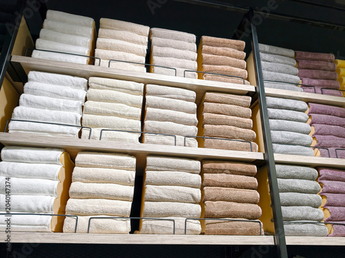 Fotografie Neatly folded cotton towels in multiple colors on large shelves in superstore