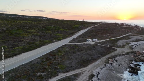 Sunset Over Rocky South Africa Coastline, Aerial Drone Sweep Reveals Winding Coastal Road, Scattered Boulders,