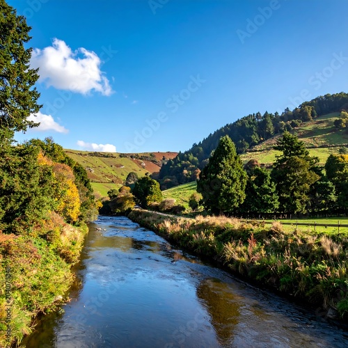 Serene river winding through lush green valley landscape.