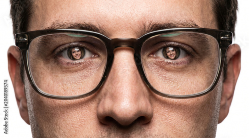 Man with glasses, serious expression, reflecting a woman in his eyes, neutral background