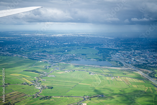 Schilderij op canvas Aerial view approaching amsterdam over dutch polder landscape