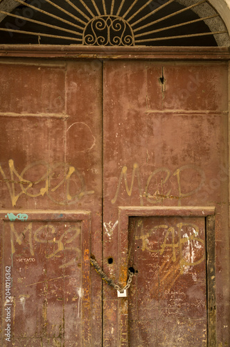 Locked door with urban graffiti.