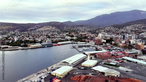 Warehouses on Derwent river Hobart city port infrastructure aerial cityscape view.