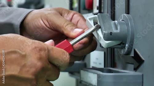 Lockout Tagout (LOTO) safety procedure using a padlock on the main electrical disconnect switch to isolate hazardous energy, ensuring worker protection during maintenance, inspection, and repair activ