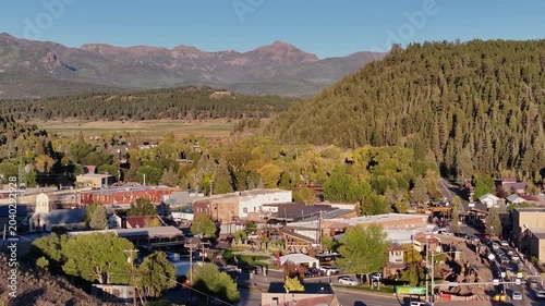 Aerial view of Pagosa Springs, Colorado aera fall landscapes capturing autumn colors and natural scenery of San Juan Mountains at golden hour sunset - 4K Drone