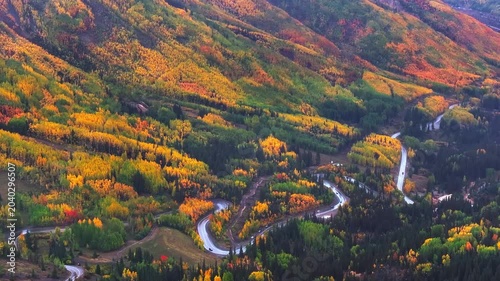 Panoramic aerial view of Colorado fall landscapes along Million Dollar Highway and Red Mountain Overlook with valley views of fall foliage trees in San Juan Mountains during autumn season - 4K Drone
