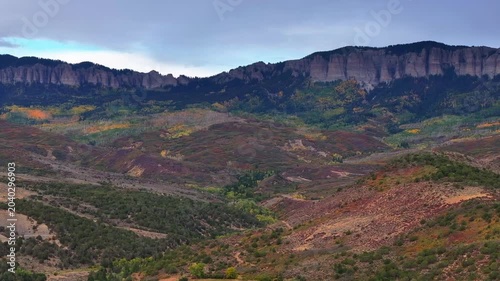 Aerial view of Colorado fall landscapes featuring mountain fall foliage trees while capturing the beauty of Uncompahgre National Forest in the San Juan Mountain wilderness - 4K Drone
