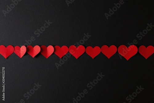 a bunch of red hearts on a black background