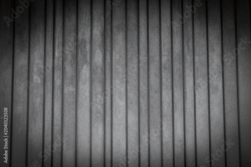 a black and white photo of a metal wall