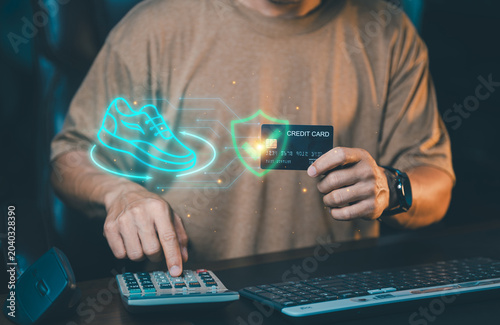 Man holding credit card with virtual running shoe icon and secure shield. Online fashion shopping, sportswear e-commerce concept.