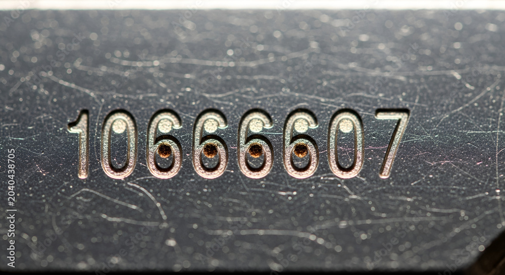 Fototapeta premium Close-up of Number Sequence on Dark Surface, Grunge Texture