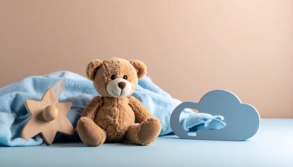 A teddy bear sits with a blue blanket, wooden star, and cloud