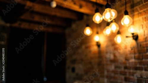 Dimly lit brick wall featuring warm glowing amber bokeh lights in a rustic interior
