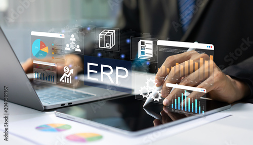 Schilderij op canvas Businessman managing ERP software system on tablet and laptop with digital dashboards for enterprise resource planning and business analytics, workflow automation, business intelligence