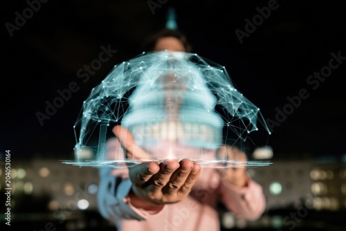 Digital hologram of a government dome building held in a hand for civic technology presentations, political news coverage and cybersecurity marketing with a dark background