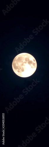 Full moon shining brightly in a dark blue night sky, blue, shining