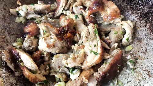 Stir-fried roasted duck with basil in pan, indoor Chiangmai Thailand.