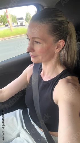 a happy young girl travels by car 