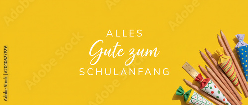 Schulanfang banner with school cones and pencils lying on flat lay bright yellow background for card design celebrating enrollment day first day of school education joy success template blank space.