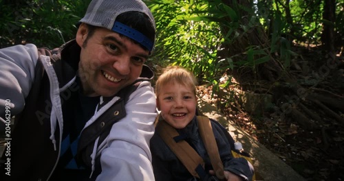 Father and son doing a selfie on old steps of Japanese village forest