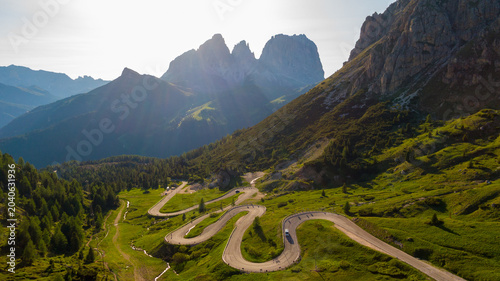 Golden hour aerial view of a Dolomites Passo Pordoi mountain pass village in Italy