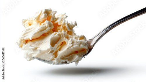 A spoonful of creamy butter creating a luxurious texture on a bright background, representing indulgence and comfort in culinary preparations.