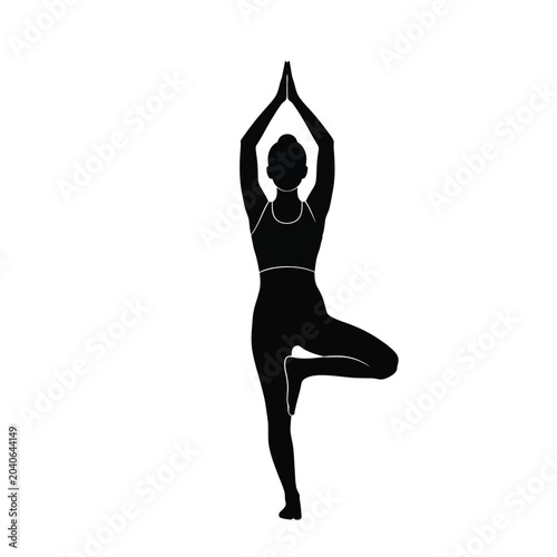woman in black silhouette practicing tree pose during yoga