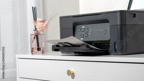 Fényképezés Modern printer sits on clean white drawer