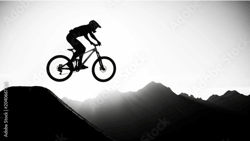 Tableau sur toile Mountain Biker Jumping Over a Hill Silhouette at Sunset