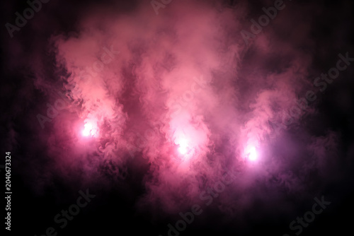 Pink smoke flares on black background.