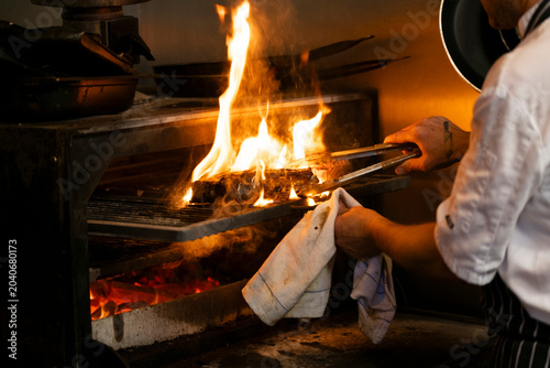 Grilling With Passion at a Vibrant Outdoor Kitchen During a Summer Evening
