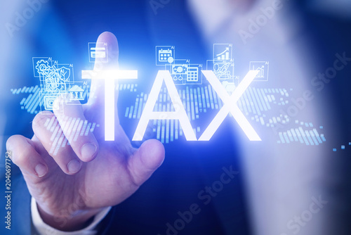 Business person interacts with digital tax symbols on background of world map at office during working hours