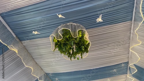 Elegant wedding tent ceiling decoration with white fabric and fairy lights