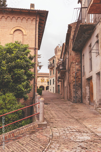 View of narrow street in Montelupone, Marche, Italy.