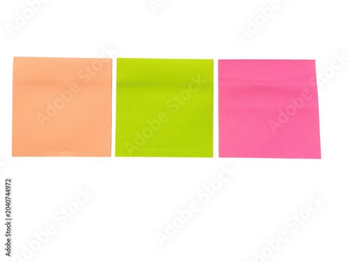 Three colorful sticky notes in a row on a flat surface