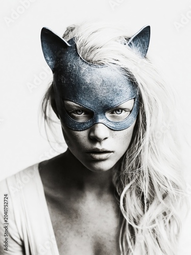 Futuristic fashion portrait of a beautiful young albino woman, looking into the camera, she is wearing an haute couture  latex suit and mask with cat ears
