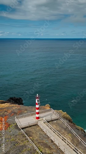 Lighthouse on scenic coast of Sao Miguel Island Azores archipelago, Aerial drone shot