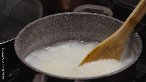 Cooking ghomi, a popular dish from the Samegrelo region made with coarse white corn flour