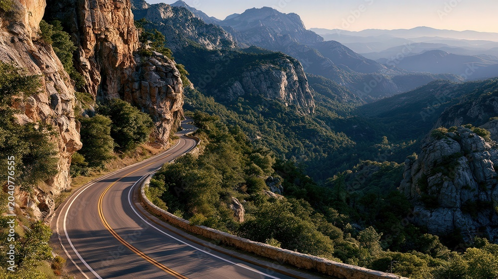 Fototapeta premium Winding road hugs mountain cliffs at sunrise