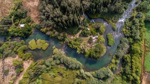 estuary. Multiple small streams merging into a single wide river viewed from above, showing water flow patterns. travel magazines, destination branding, designed for travel destination branding.