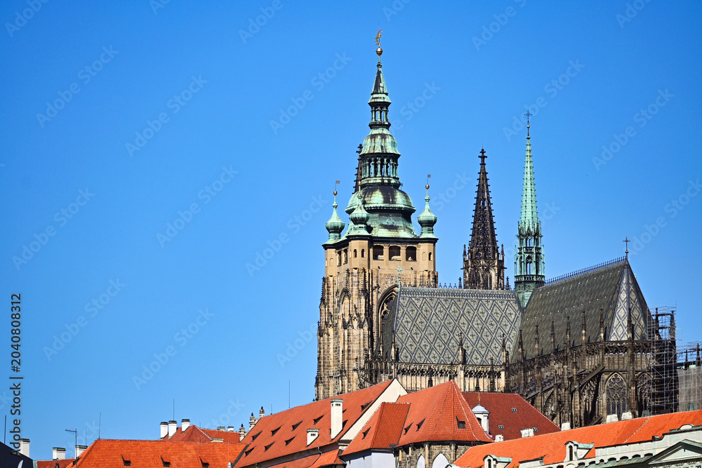 Fototapeta premium Saint Vitus Cathedral Great South Tower Rising Above Red Rooftops in Prague
